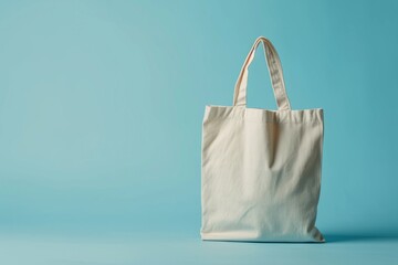 Wall Mural - White tote bag without words isolated on light blue background. Mock up