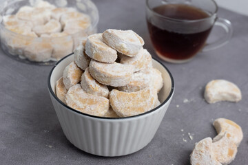 Kue Putri Salju are cute crescent shaped vanilla cookies with a crumbly, and covered in confectioners sugar. Indonesian dry cakes, for the celebration of Eid al-Fitr