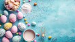 Easter baking background. Pastel colored eggs, flour, whisk and candy on blue background. Flat lay, top view