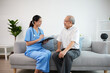 © offsuperphoto - nurse or caregiver holding a clipboard meeting and talking about health with elderly man