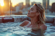 A serene blonde model enjoying a spa hot tub during twilight with last sun rays and busy city skyline in background