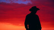 A cowboy silhouette against a backdrop of a minimal, colorful sunset.