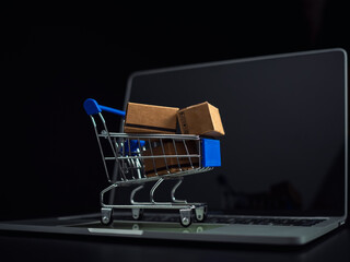 Boxes in a shopping car on a laptop keyboard. Ideas about online shopping, online shopping is a form of electronic commerce that allows consumers to directly buy goods from seller over the internet.