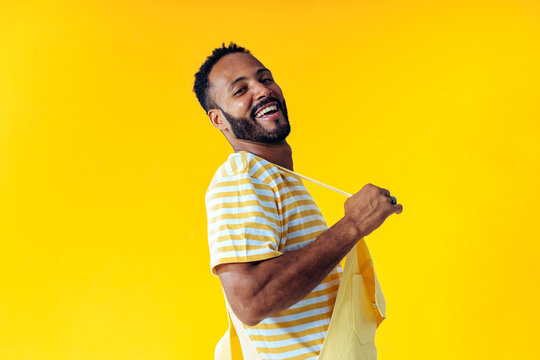 image of an handsome young man posing on colored backgrounds wearing colorful trendy clothes. concep