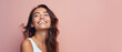 © Synthetica - Portrait of a beautiful young woman smiling on a pink background .