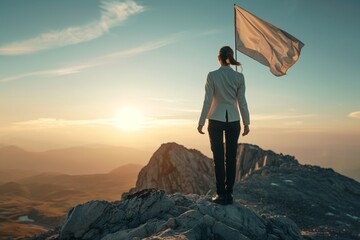 businesswoman standing top of mountain winner flag on back view