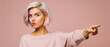 © Synthetica - Portrait of a beautiful young blonde woman with short hair in a pink sweater on a pink background