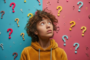 Wall Mural - Young girl looking up at question marks, vibrant background expressing curiosity and thought