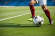 © Maftuh - close-up photo of a professional soccer player playing football on a green grass pitch at a big stadium. dribbling the ball against opponents. soccer match on a field