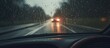 Driving in heavy rain on the highway. Blurry raindrops on the windscreen, obscuring the road ahead.