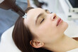 © Dasha Petrenko - Woman treating client face with laser