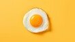 Fried egg isolated on yellow background. Top view