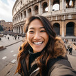 POV of a smiling asian woman taking a selfie with the Roman coliseum in the background