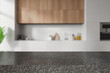 Grey stone counter on background of kitchen interior with kitchenware. Mockup
