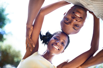 Wall Mural - Happy, nature and bottom portrait of black couple on a valentines day date in a garden or park. Smile, love and young African man and woman bonding on adventure in outdoor field from below together.