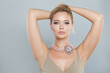 Beautiful woman with healthy skin standing with hand up. Female armpit