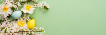 Festive Banner With Spring Flowers And Easter Eggs, White Daffodils And Cherry Blossom Branches On A Green Pastel Background