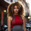 girl in tight red sports top with blonde died curly hair