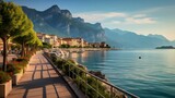 Fototapeta  - City of Riva del Garda by Garda lake in Italy. View from the promenade to see in the early morning