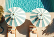 © DP - Striped blue and white umbrellas, sun beds, pots with plants and a swimming pool