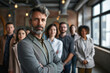 © Viorel Sima - confident businessman crossing arms and being a leader in front of his team