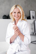 © brizmaker - Smiling happy middle aged woman touching soft skin on hands