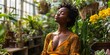 Achieve calmness and mindfulness with deep breathing and a serene mindset in a lush indoor garden with a grateful African woman.