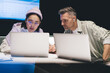 © BullRun - Skilled male and female colleagues browsing website on modern laptop computers while brainstorming in office interior, professional employees connecting to 4g wireless on netbook for reading news