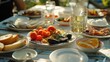 A table filled with plates of food and glasses of wine. Perfect for restaurant promotions or food and beverage advertisements