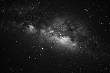 Wall Mural - A stunning black and white photo capturing the beauty of the Milky Way. Perfect for astronomy enthusiasts or those seeking a sense of wonder.