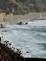 Corniglia, 5 Terre, Italy - January 05, 2024: Beautiful photography of the Cinque Terre landscape. Spectacular  view of the waves with blue sky in the background in winter days. 