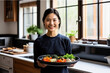 Young Chinese woman embodies health and beauty in her home kitchen, crafting a fresh and nutritious vegetarian meal.