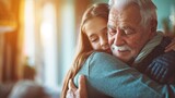 Fototapeta  - A tender moment as an elderly man hugs a young girl, likely his granddaughter, with a warm and affectionate embrace.