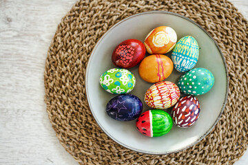 Wall Mural - Colorful Easter eggs hand-painted at home. Using food coloring to dye Easter eggs. Painting eggs with candle wax. Getting ready for Easter egg hunt.