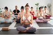 © CarlosBarquero - Group diverse fitness young people practicing yoga mudra exercises in class, asana posture with eyes closed. Concentrated meditating women and man in sportswear. Healthy and wellness in community.