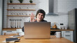 © mahirkart - Smiling young man sitting in the kitchen having video call conversation through using laptop computer. Share news, talk to family, enjoy webchat virtual meeting