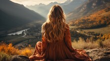 Girl Sitting On A Rock Looking At A Mountain Landscape