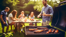 A Photo Of A Family And Friends Having A Picnic Barbeque Grill In The Garden. Having Fun Eating And Enjoying Time. Sunny Day In The Summer. Blur Background.