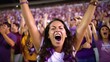 woman and group of fans celebrating and screaming supporting team in stadium seats wearing purple. Group of men and women spectators cheering for their team victory.
