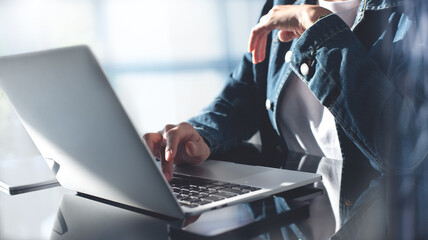 Sticker - Closeup, business woman hands working and typing on laptop keyboard on glass table. Woman freelancer online working on laptop from home office, remotely work, distant job, social networking