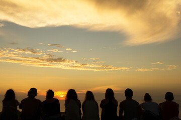 Group of people looking at sunset