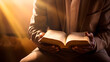 © Gomez - man reading the bible while a ray of sunlight shines on him