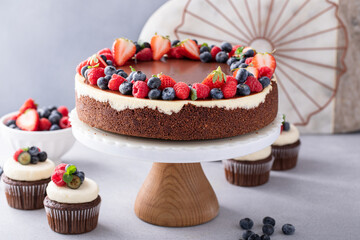 Wall Mural - Chocolate and vanilla cheesecake topped with chocolate ganache and fresh berries