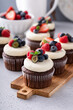 Chocolate cupcakes with vanilla frosting and fresh berries
