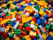 Pile of multi-colored plastic Lego pieces on table