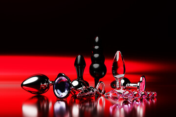 Set of the  butt anal plugs sex toys on   red isolated background. 3D illustration. Empty space for your text