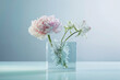 Elegant peony and amaryllis blossoms in a glass cube vase, with submerged greenery creating a dreamy, ice-encased effect