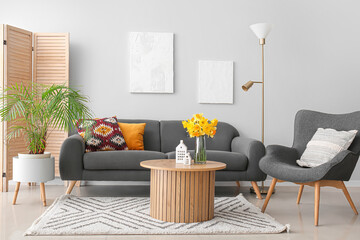 Wall Mural - Interior of modern living room with cozy sofa, armchair and coffee table