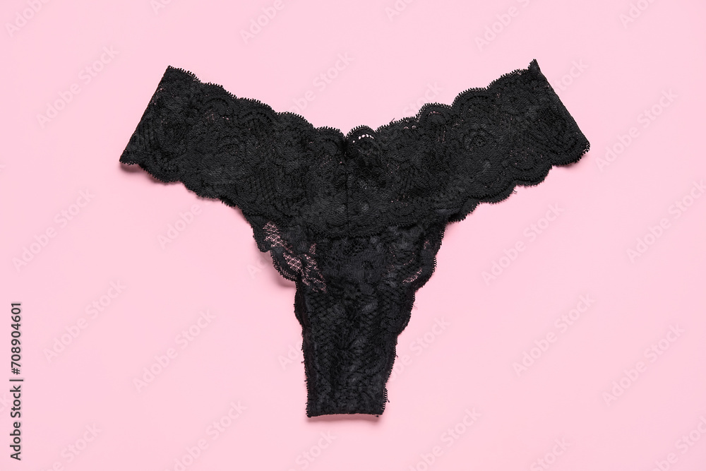 Black female panties on pink background