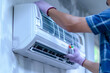 © praewpailyn - Male Hand Technician , Indoor Air Conditioner Maintenance